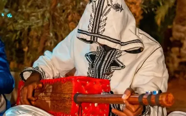  An Algerian musician playing desert music, reflecting the cultural diversity of Algeria.
