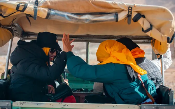 Two tourists enjoying the 4X4 experience in the Algerian desert.